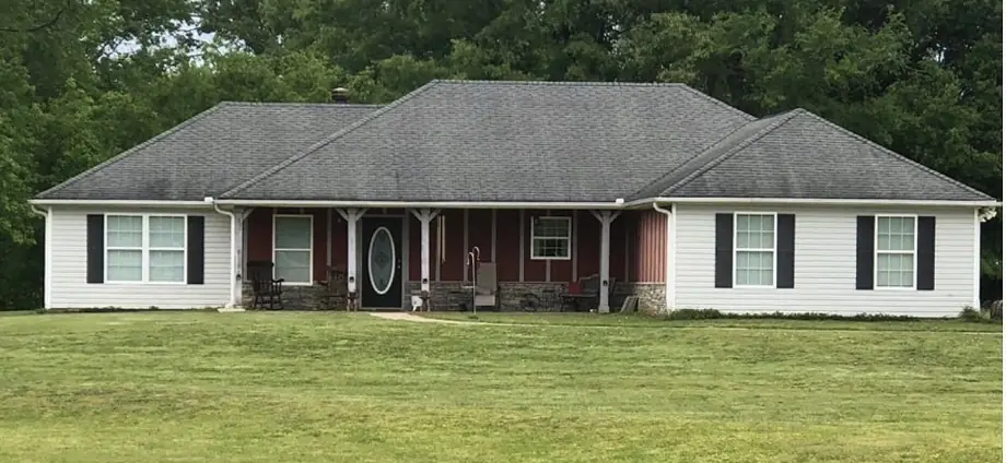 Storm-damaged roof before repair